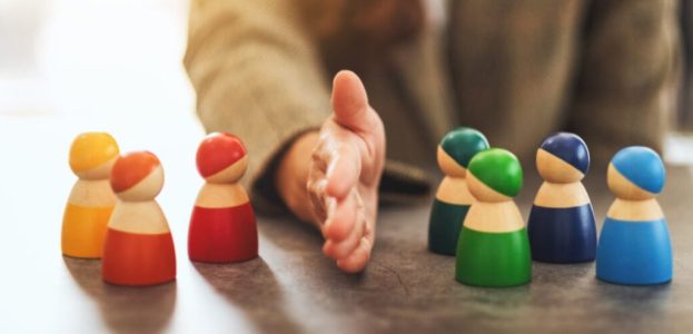 a business woman separate wooden people into two group a business woman separate wooden people into two group