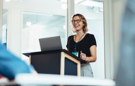 Female business professional addressing a seminar Female business professional addressing a seminar