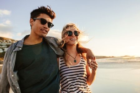 Young couple enjoying a summer day on seashore Young couple enjoying a summer day on seashore