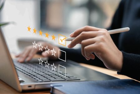 Businessman typing on a computer keyboard, customer service satisfaction survey concept. Business people choose the highest satisfaction rating and give 5 stars. Satisfaction, rating, rating. Businessman typing on a computer keyboard, customer service satisfaction survey concept. Business people choose the highest satisfaction rating and give 5 stars. Satisfaction, rating, rating.