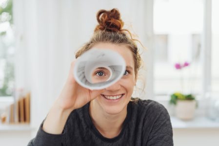 Young woman playing I spy with the camera Young woman playing I spy with the camera