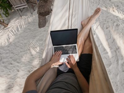 workation, remote work, freelancer with laptop in hammock