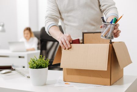 Upset office manager packing the box and leaving the office Upset office manager packing the box and leaving the office